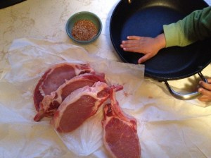 Fresh cut pork chops, meddling hands